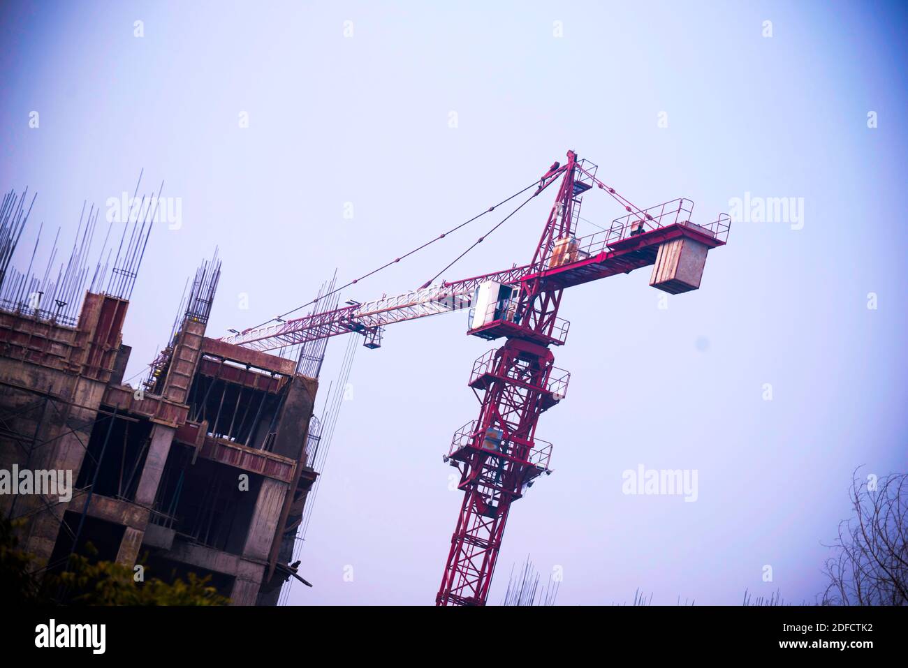 Cranes on a construction site. Building construction site with tower cranes against blue sky. Stock Photo