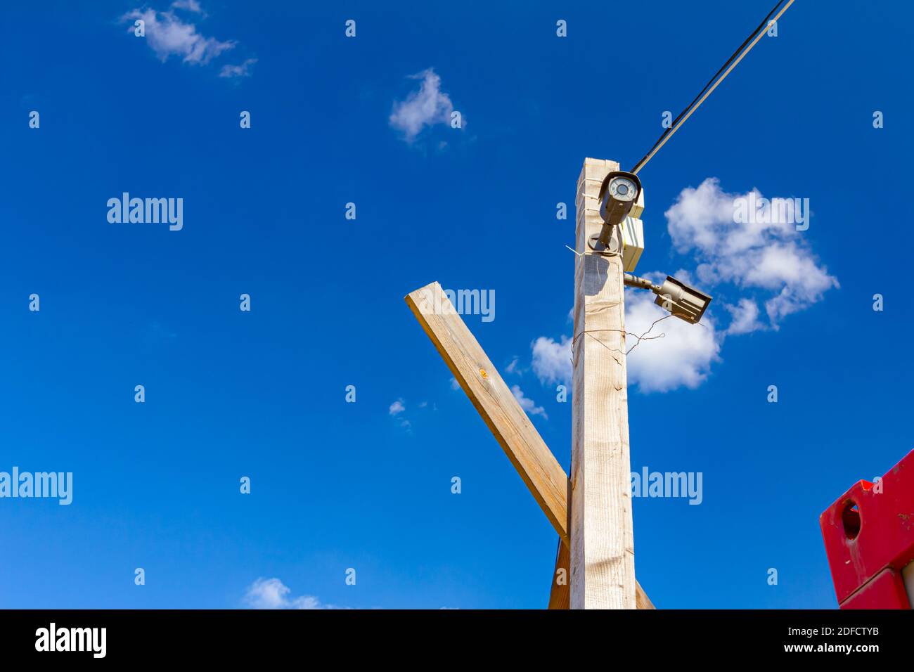 Security cameras are placed on the wooden pole for protection. Stock Photo