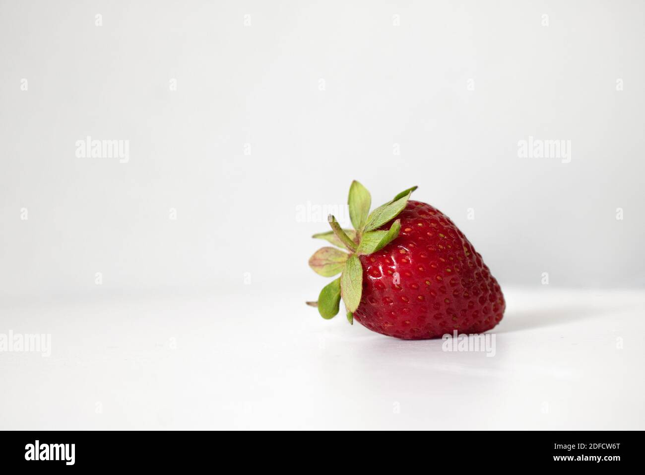 Vibrant strawberry lying on white background. Space for text. Health, nutrition and healthy eating concept Stock Photo