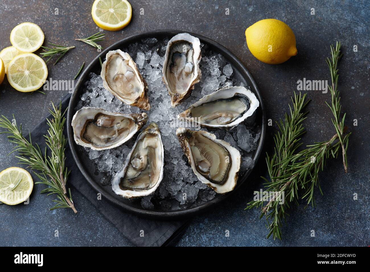 Fresh opened oysters on ice, textured background Stock Photo