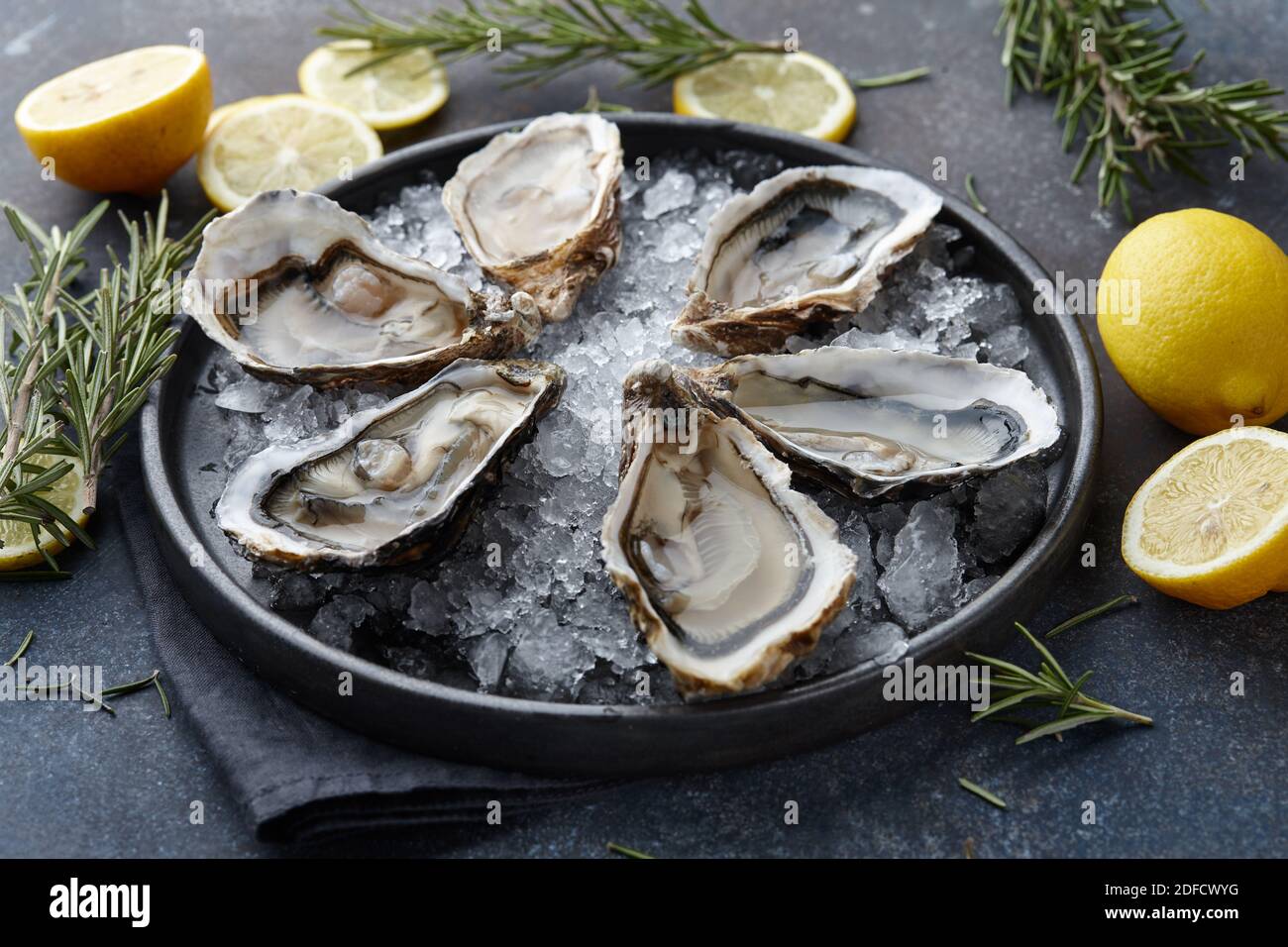 Fresh opened oysters on ice, textured background Stock Photo