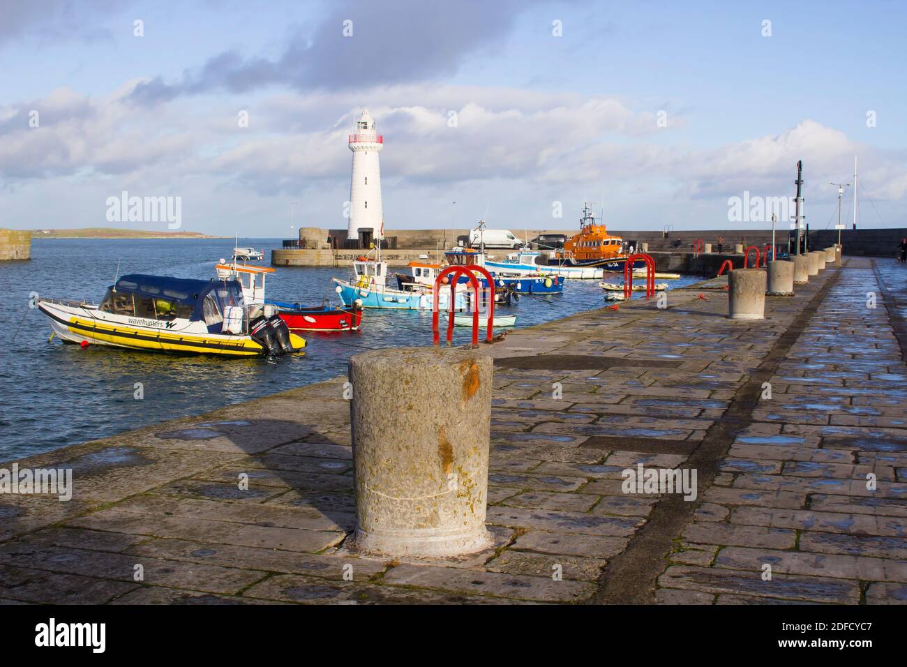 2 December 2020 Donaghadee Harbour and Lighthouse on the Ards Peninsula in Northern Ireland bathed in winter sunshine on a bight yet cold winter after Stock Photo