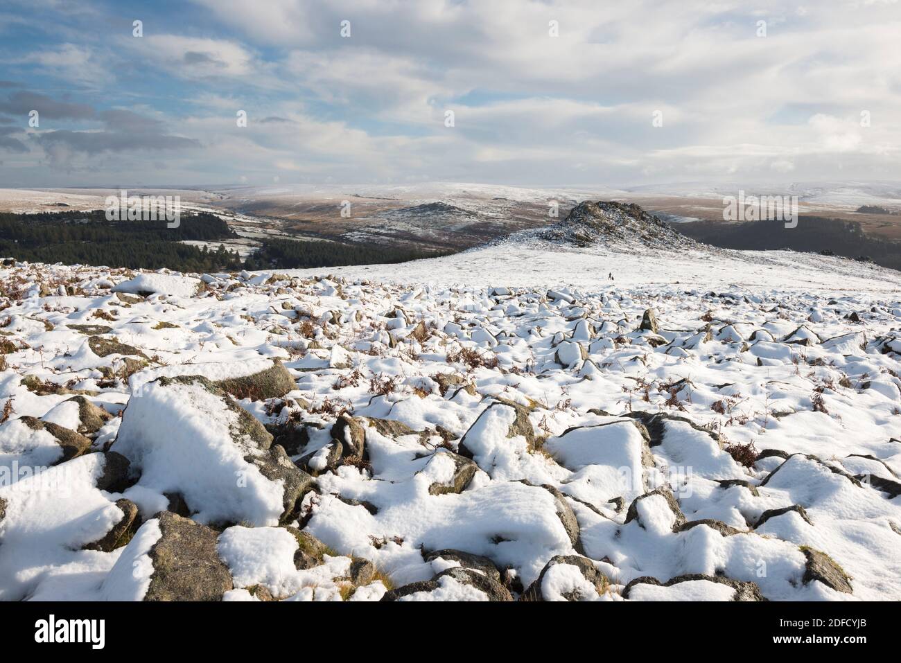 Sharpitor Dartmoor, Devon, UK.  4th December 2020.  UK Weather.    Snow covers the rocks at Sharpitor on Dartmoor in Devon looking towards Leather Tor on a cold wintery day.  Picture Credit: Graham Hunt/Alamy Live News Stock Photo