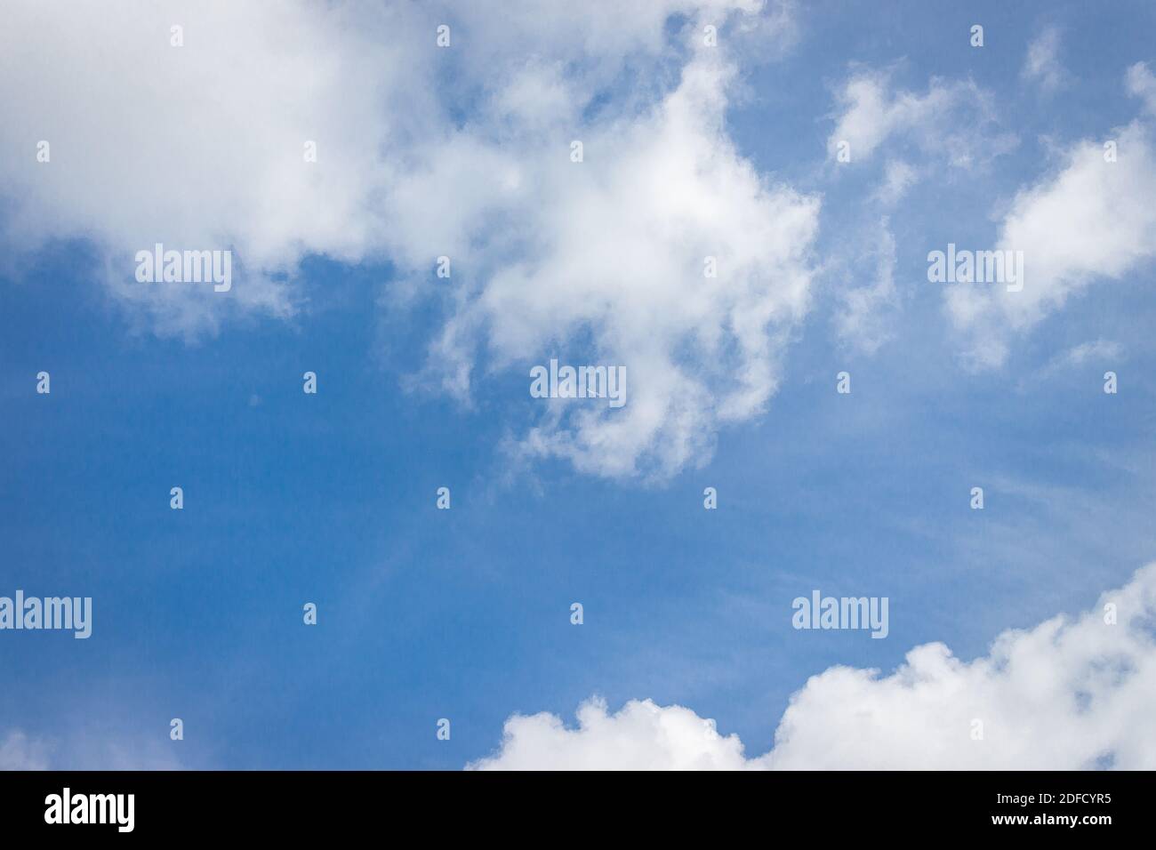 A blue sky covered with white puffy clouds Stock Photo - Alamy