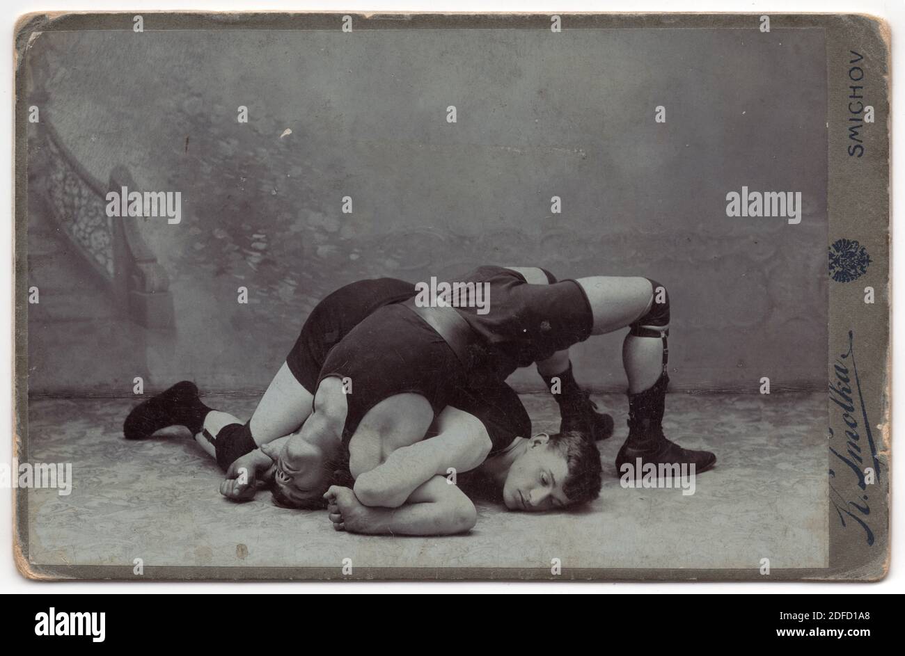 Two fighting wrestlers depicted in the black and white vintage photograph pictured by Czech photographer Karel Smolka probably in the beginning of the 20th century in his atelier in Smíchov district in Prague, Austro-Hungarian Empire. Courtesy of the Azoor Photo Collection. Stock Photo