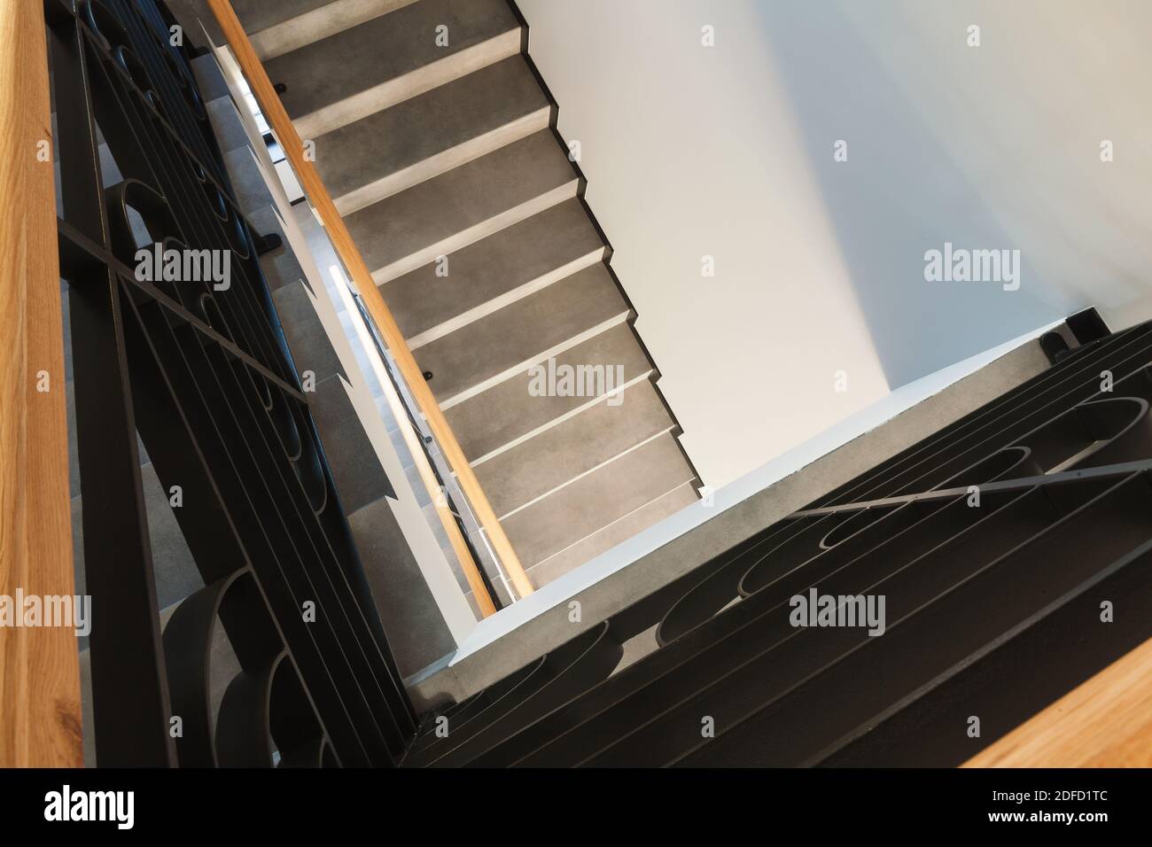 Details of a new and modern stairs in the house, decorative gates and marble steps. Stock Photo