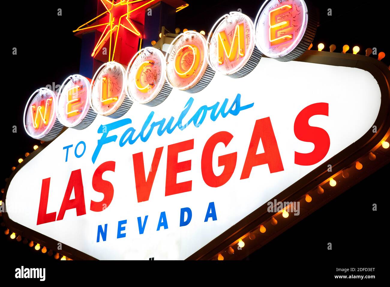 Famous Welcome to Fabulous Las Vegas sign superimposed over view of  southern end of Las Vegas at dawn Stock Photo - Alamy