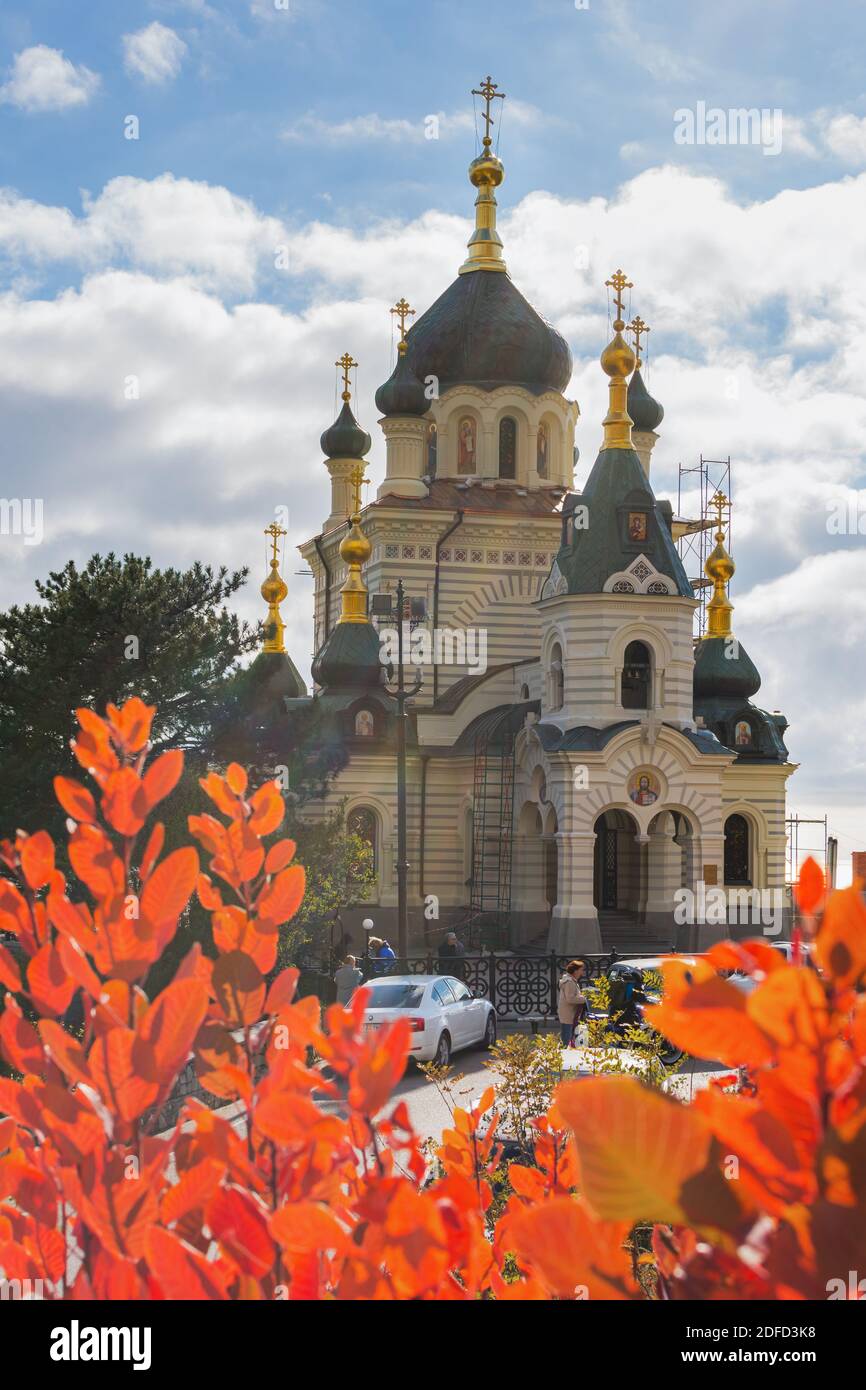 Foros Church in the autumn of Crimea on November 07, 2020. Church Of The Resurrection. Close-up view through the red scumpia. A popular tourist destin Stock Photo