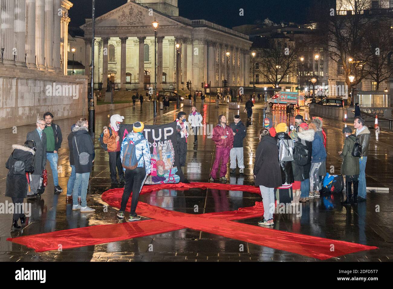 Activists attend the flashmob event HIVisible : Our Bodies Tell Our HIV Stories to mark World AIDS Day (Dec 1st) on Thursday 3rd December in Trafalgar Square,London. Patrick Braithwaite speaking with Silvia Petretti, Neo Moepi, Tresca Wilson, Ejel Khan (Muslim LGBT Network), Patrick Braithwaite, Paolo Zerial, Shamal Waraich and MC Jarek Kubiak.  https://actuplondon.wordpress.com/2020/11/18/act-up-london-flashmob-get-involved-hivisible-2gether/  ACT UP London is a diverse, non-partisan group of individuals united in anger and committed to direct action to end the HIV pandemic, along with the br Stock Photo