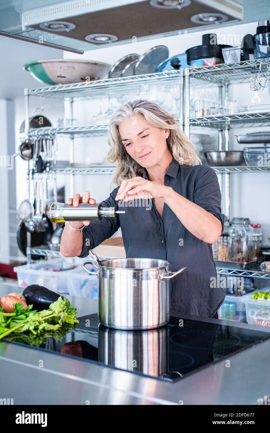 Woman cooking on an induction hob Stock Photo Alamy