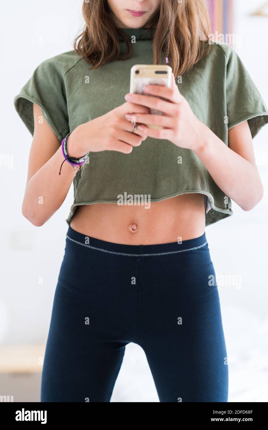 Teenage girl wearing a crop top Stock Photo - Alamy