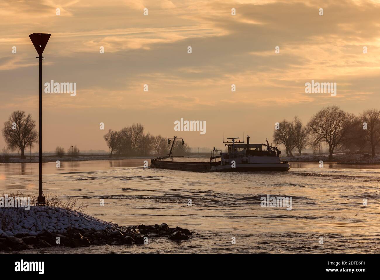 Dutch riverboat transporting goods during winter on the river IJssel Stock Photo
