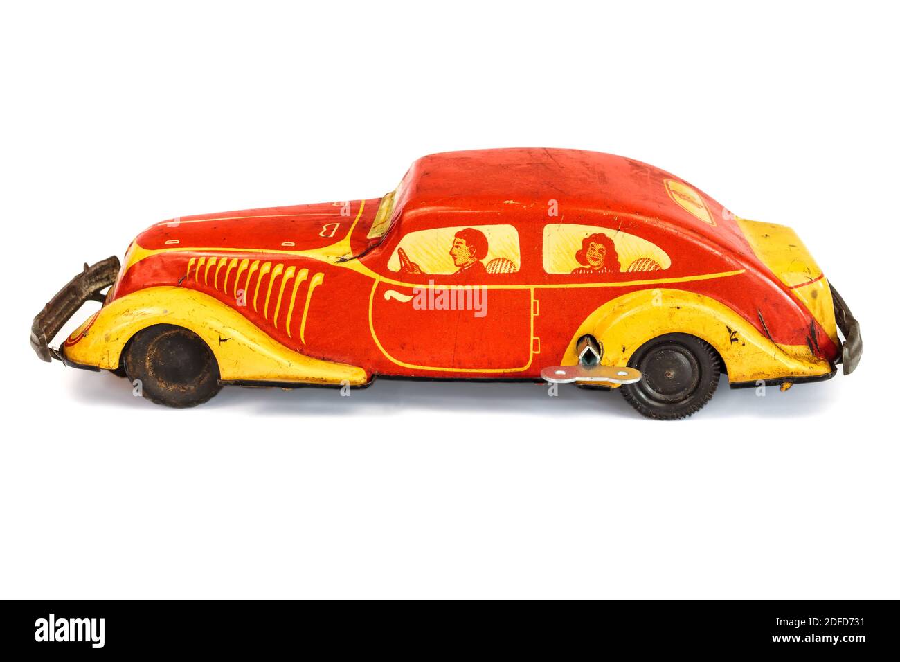 Antique wind up car toy with family inside isolated on a white background Stock Photo