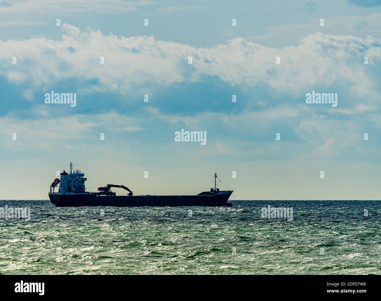 Large cargo ship with an excavator mounted on top of its hulls. . High quality photo Stock Photo