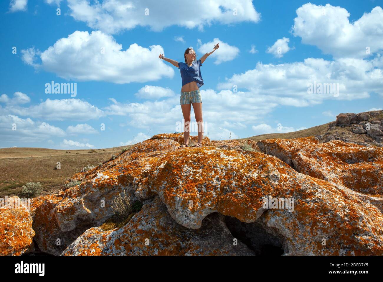 freedom woman on the peak with mountains view while she raised hands up high Stock Photo