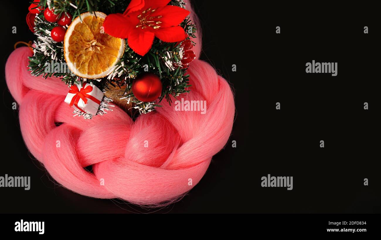 Synthetic pink kanekalon - Christmas photo with decoration on black. New Year photo for a store or hairdressing salons, barbershops Stock Photo