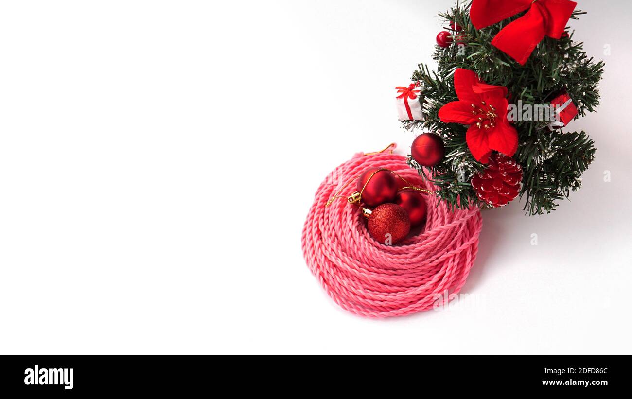 Synthetic pink kanekalon braids - Christmas photo with decoration on white. New Year photo for a store or hairdressing salons, barbershops Stock Photo