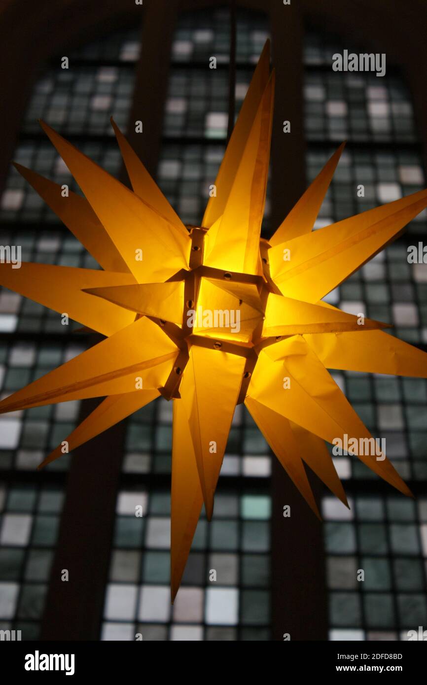 festive illuminated German Christmas star with church window Stock