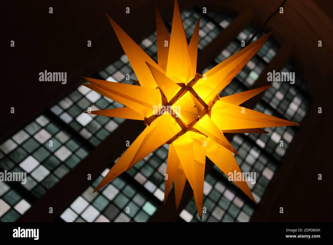 festive illuminated German Christmas star with church window Stock