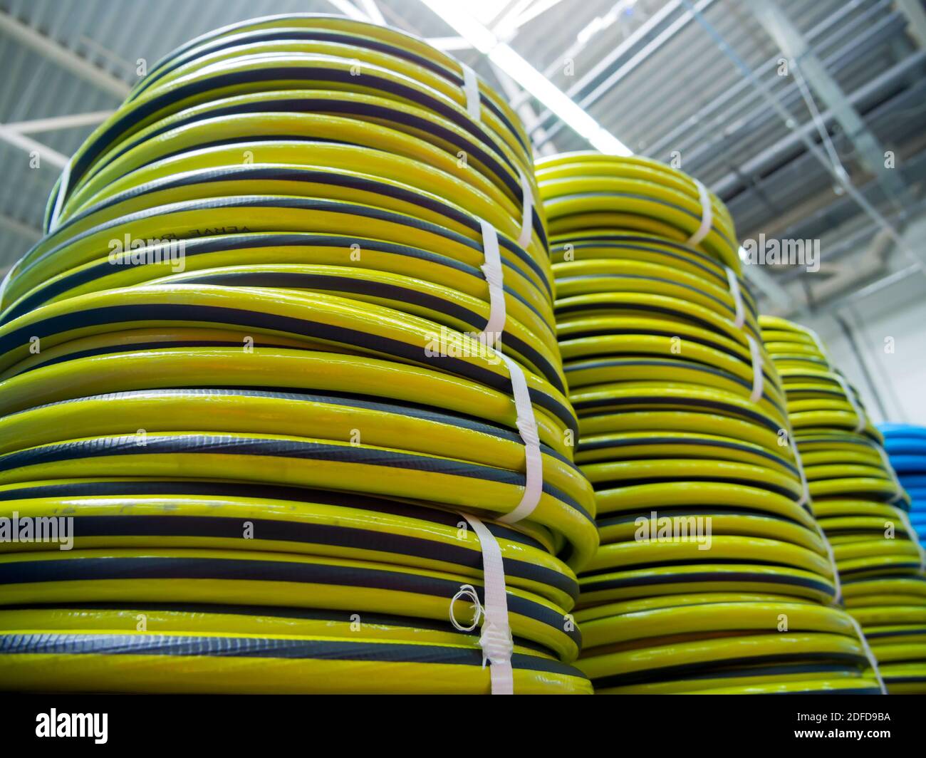 New irrigation hoses stacked in a warehouse Stock Photo Alamy