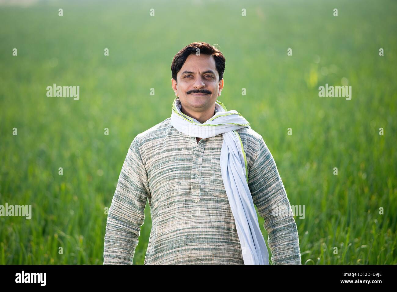 Happy Indian farmer sitting in agricultural field Stock Photo - Alamy