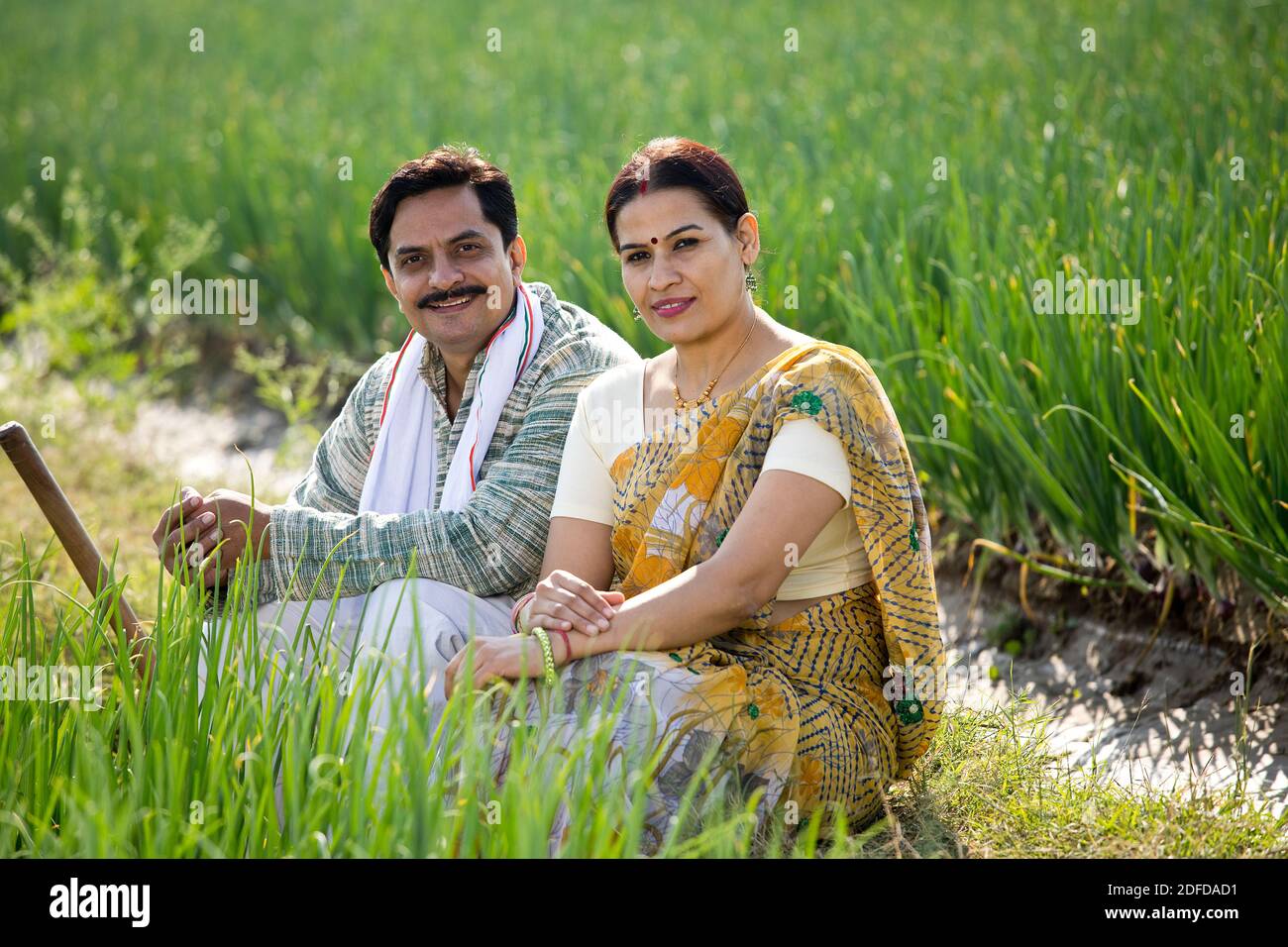 Happy Indian couple farmers examining crop in agricultural field Stock ...