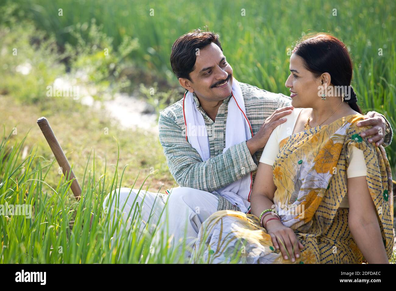 Happy Indian couple farmers examining crop in agricultural field Stock ...