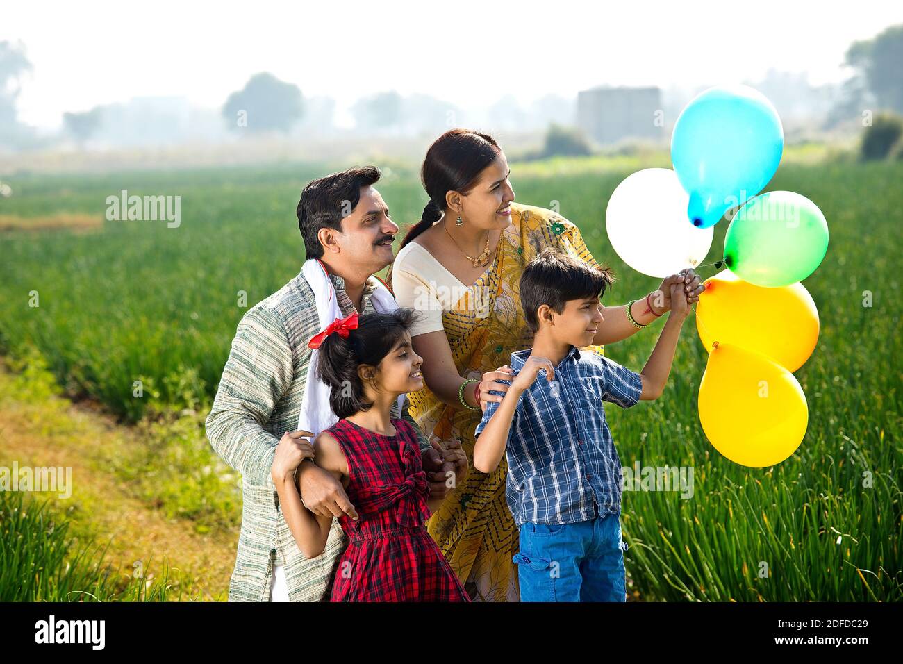 Happy family of farmer with balloons in agricultural field Stock Photo ...