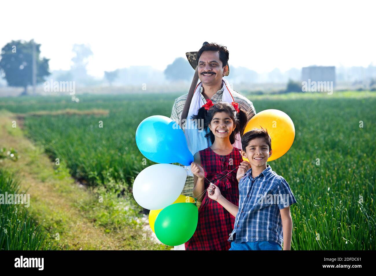 Happy family of farmer with balloons in agricultural field Stock Photo ...
