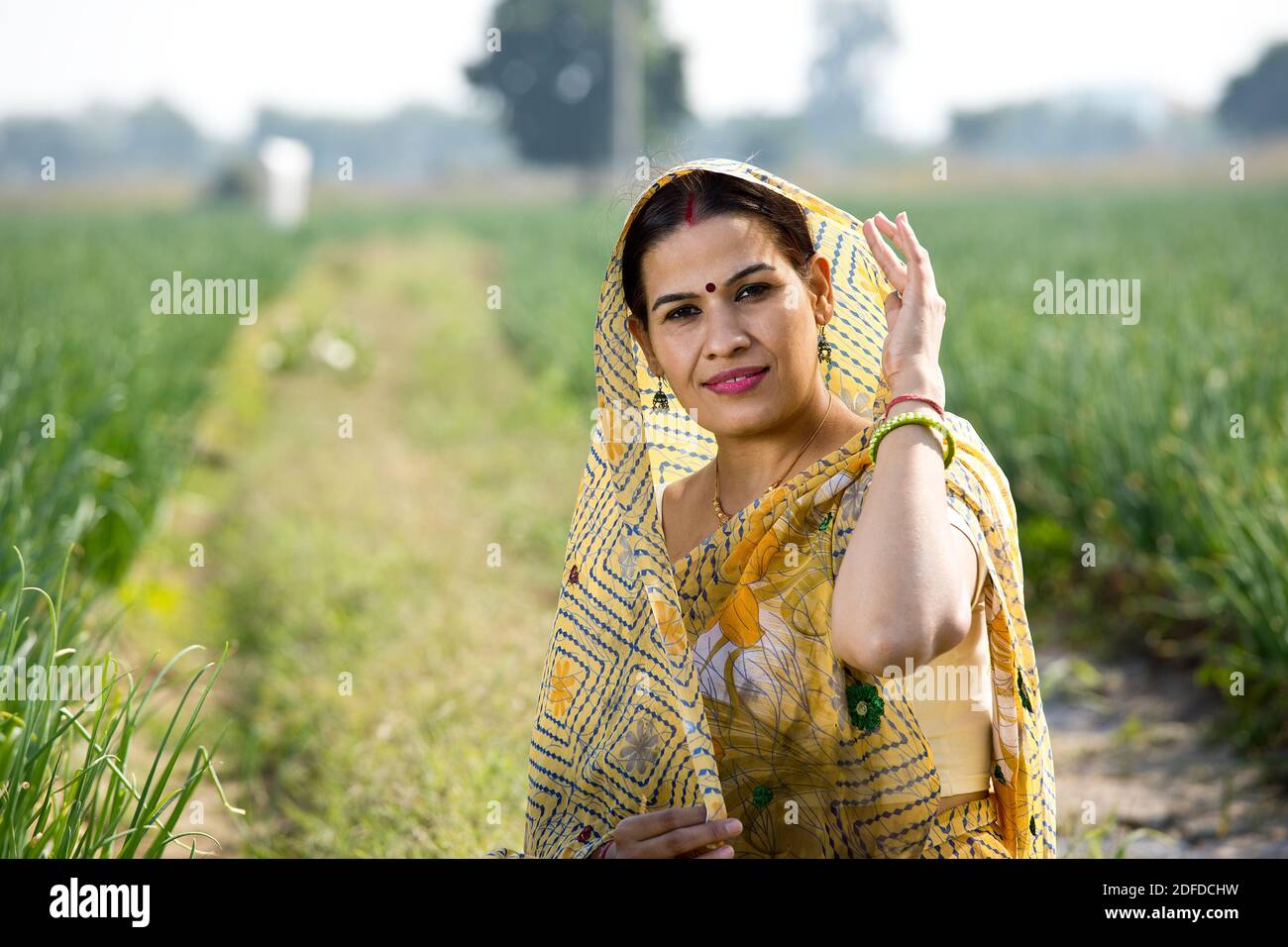 Smiling Indian woman farm owner standing in agricultural field Stock ...