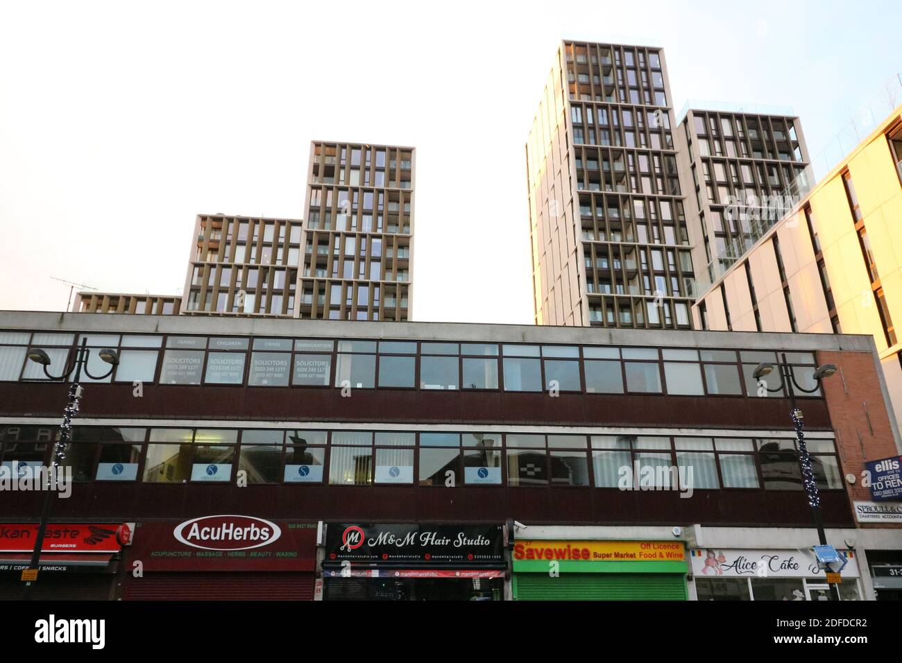 2 December 2020 - Harrow, UK: View of shops with offices and skyscrapers above Stock Photo