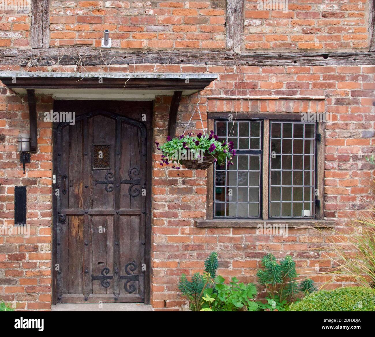 28 November 2020 - Denham, England: Door, porch and window of old village house Stock Photo