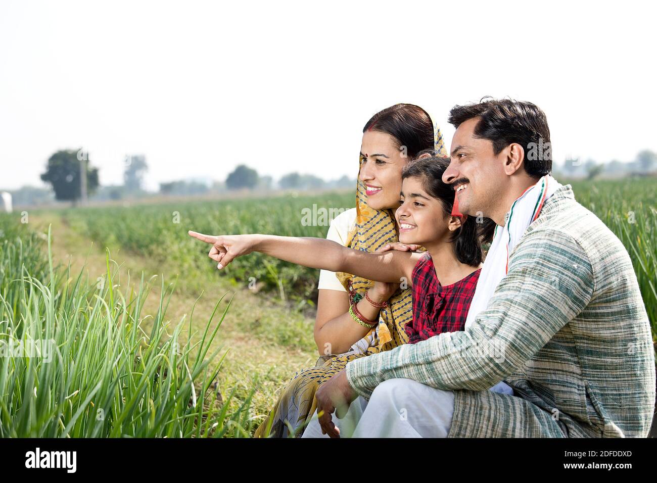 Happy indian family of farmer in agricultural field Stock Photo - Alamy