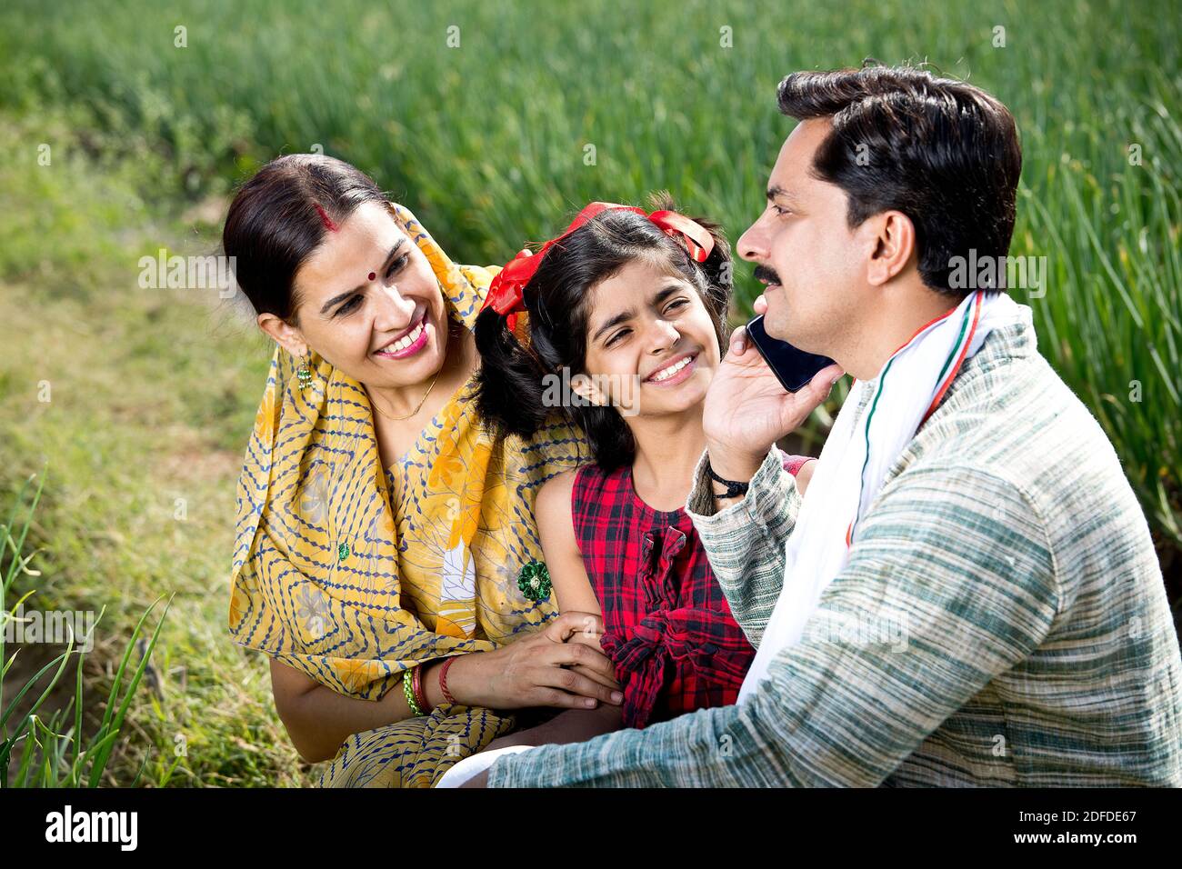 Happy indian family of farmer in agricultural field using phone Stock ...