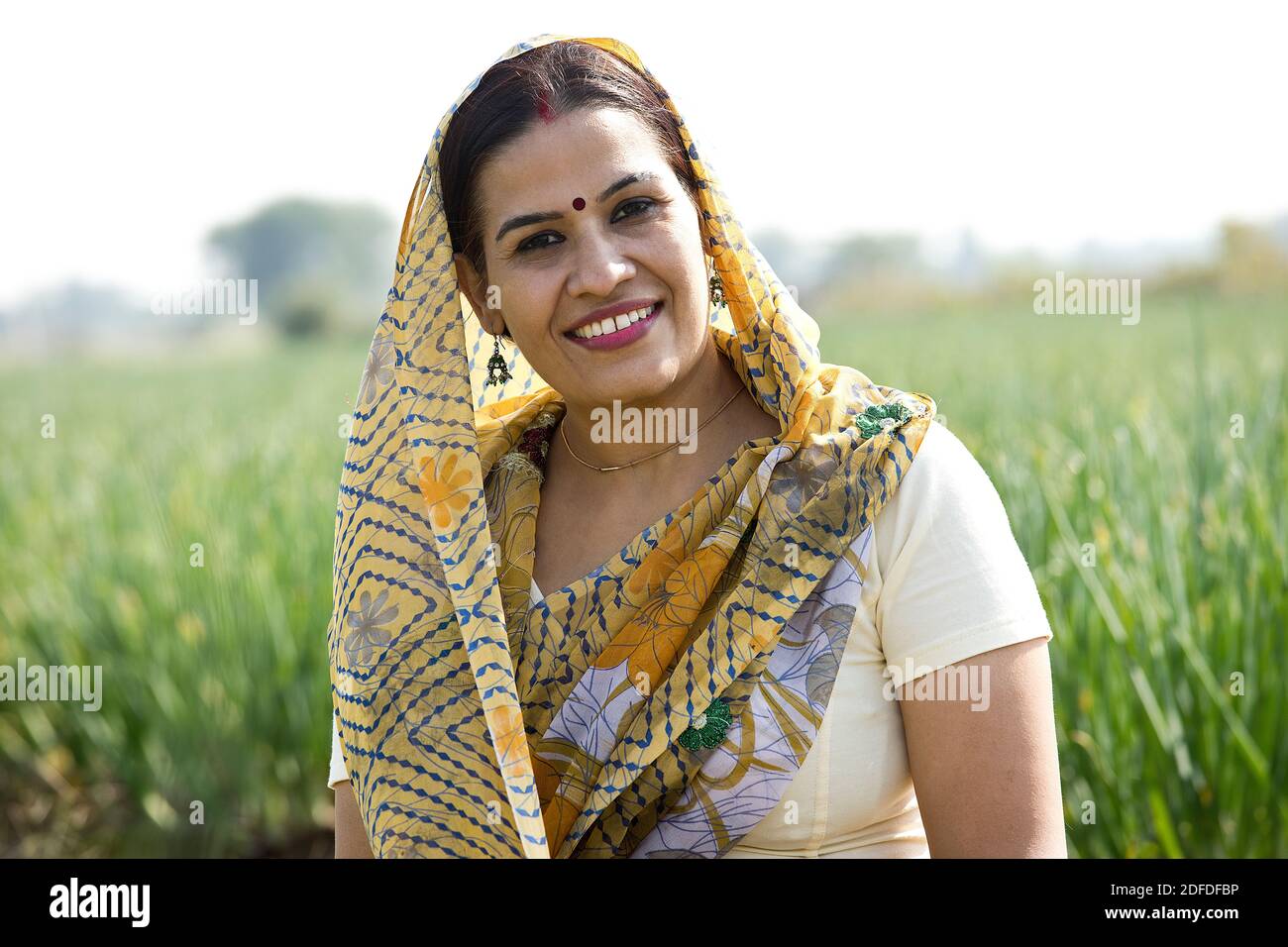 Smiling Indian woman farm owner standing in agricultural field Stock ...