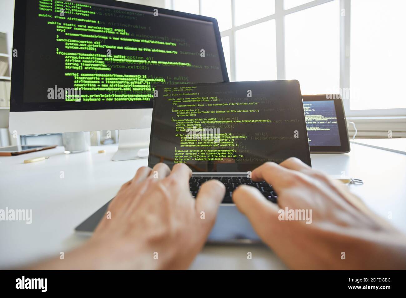 Close-up of computer programmer typing codes for new software on laptop Stock Photo