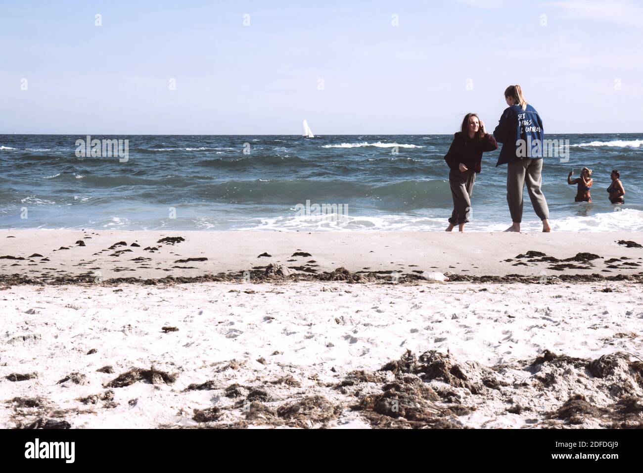 Odessa/Ukraine - October 5, 2020:Summer beach and sea. People on the beach look at the stormy sea, ocean. Beautiful white clouds in the sky Stock Photo