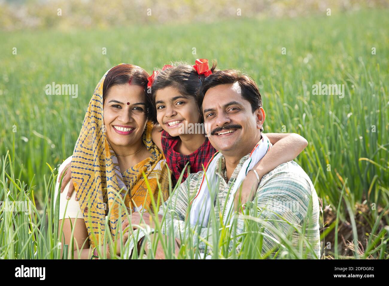 Happy Indian family in agricultural field Stock Photo - Alamy