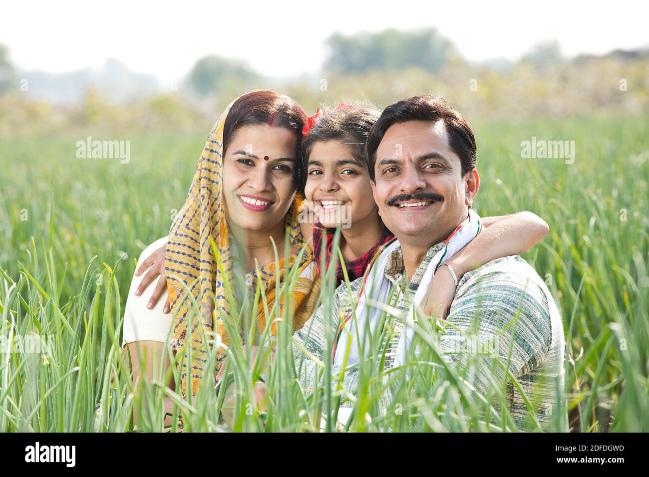 Happy Indian family in agricultural field Stock Photo