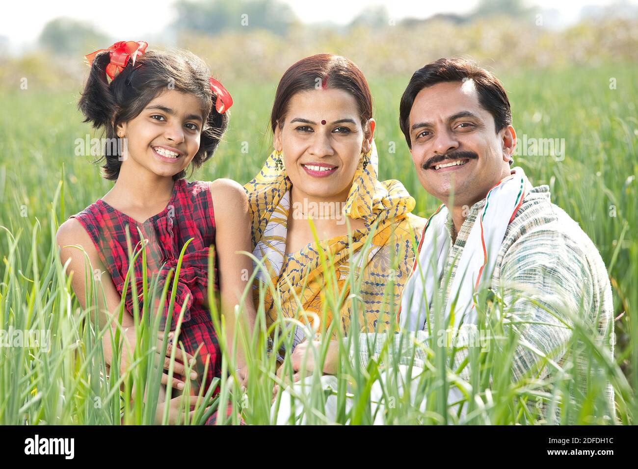 Happy Indian family in agricultural field Stock Photo - Alamy