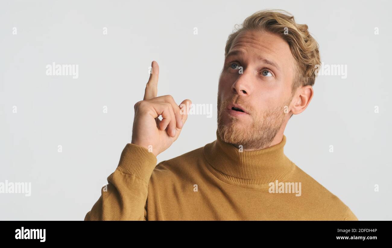 Young attractive bearded man thinking and showing new idea gesture on camera over white background Stock Photo