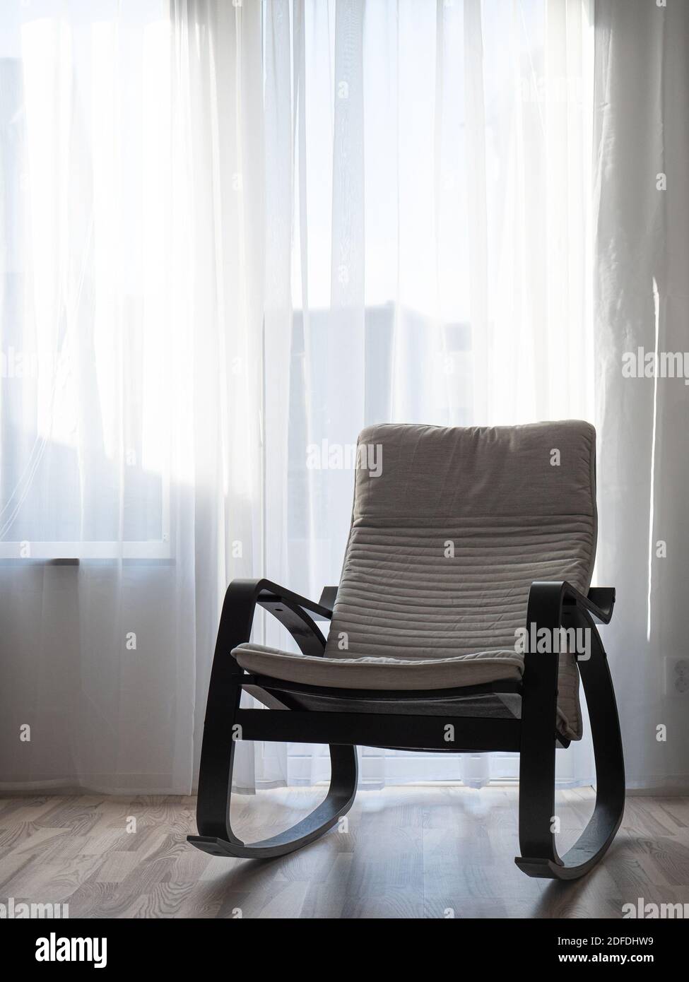 Image of Rocking chair in the morning sunshine. Light streams through ...