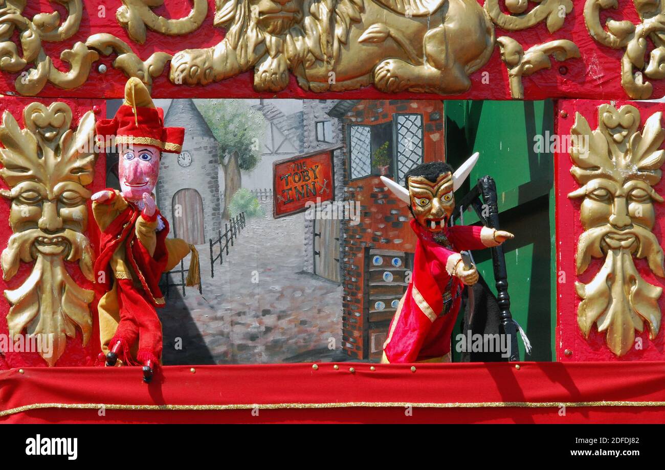 Traditional seaside end of pier sideshow, children's entertainment--a Punch and Judy puppet show. Here the trickster, Mr Punch, encounters the Devil. Stock Photo