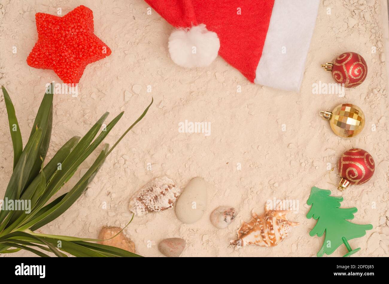 Christmas Background on the sand for travel agencies with copy space. Relax on the beach for the Christmas and New Year holidays. Stock Photo