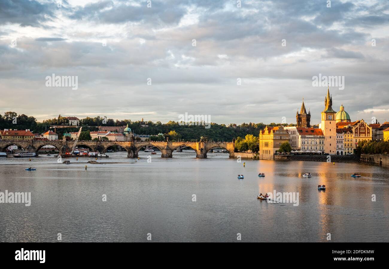 Prague and the Vlatava River, Czech Republic. Urban landscape of the famous landmark Charles Bridge and Old Town Bridge Tower at dusk. Stock Photo
