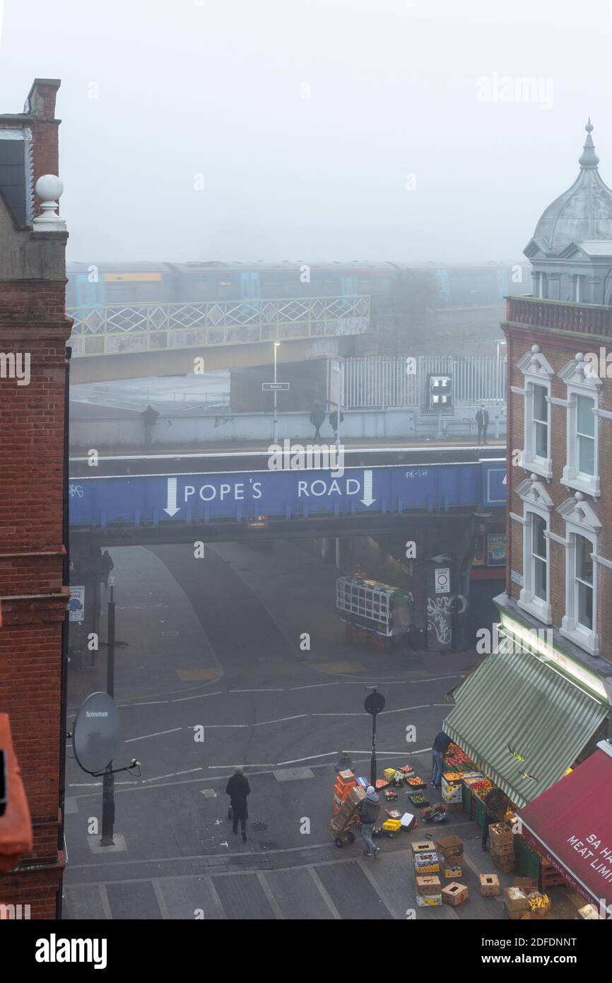 View down Electric Avenue towards Pope Road in the fog, Brixton, London Stock Photo Alamy