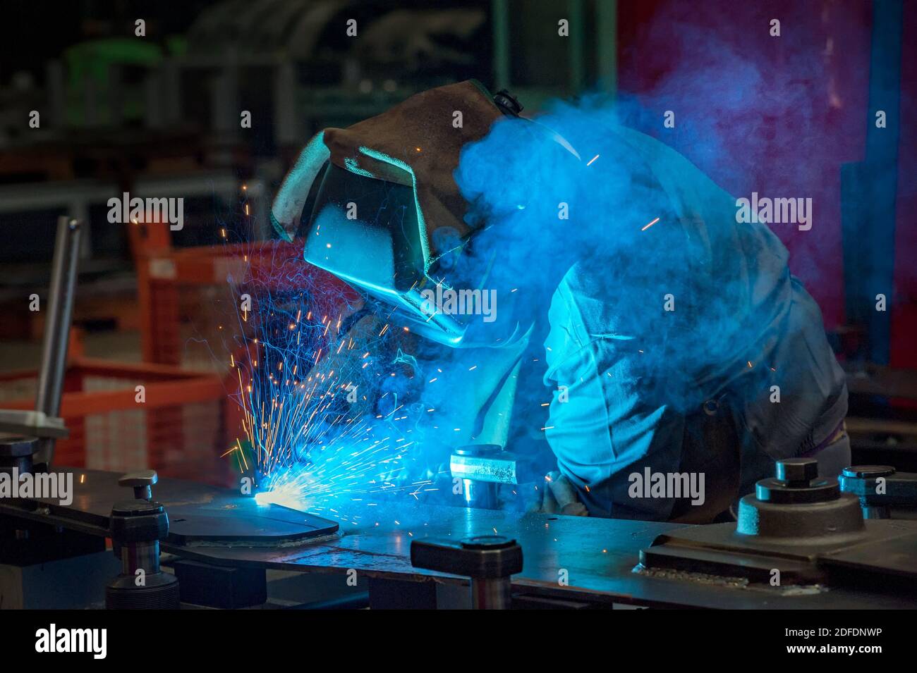 Welder at work in a factory in full protective gear Personal