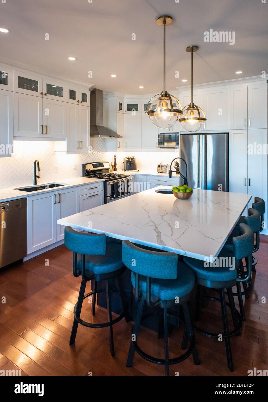 Modern Kitchen With White Cupboards Dark Island And Gold Accents Stock Photo Alamy