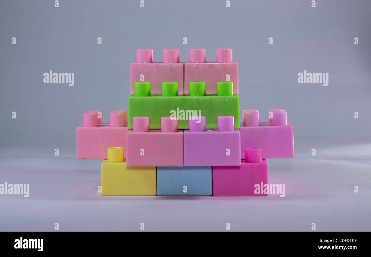 stacked toy blocks on a white background Stock Photo