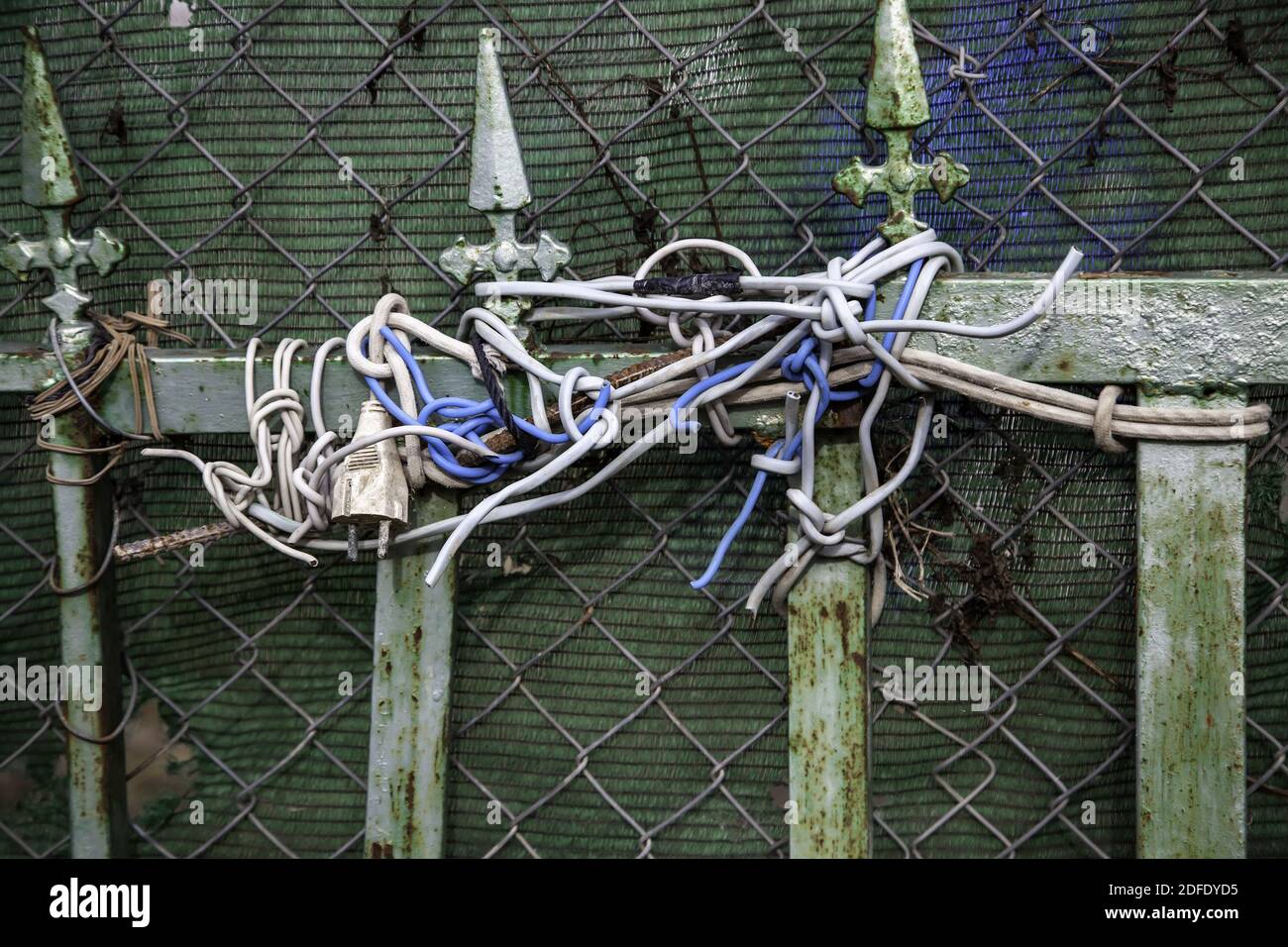 Cables tangled in door to protect, lock and security Stock Photo